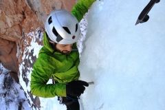 Ryan Dutch placing ice screw protection in Colorado National Monument
