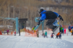 Little snowboarder on lower peace terrain park