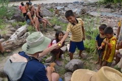 John-Cook-giving-out-gifts-to-the-local-village-kids